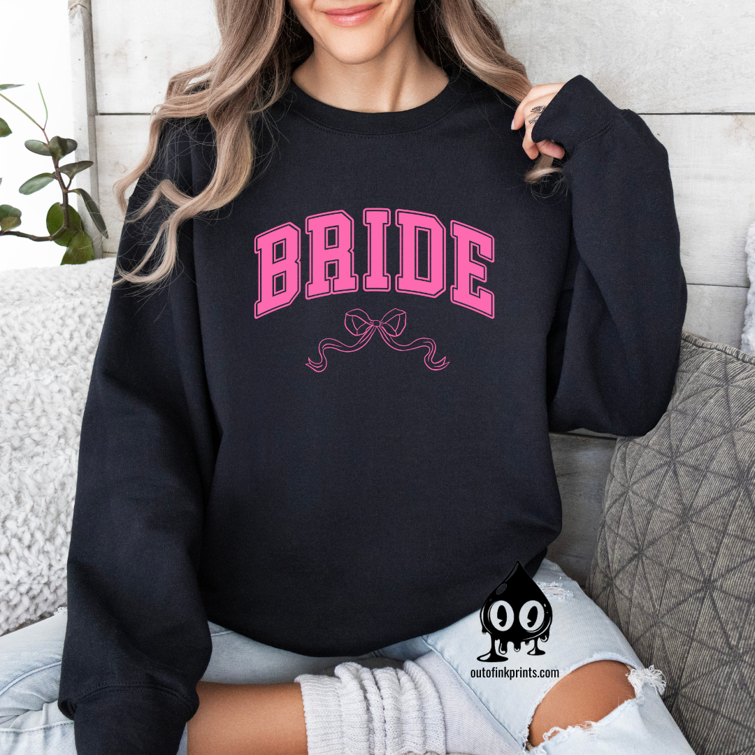Front view of a black sweatshirt with the word 'Bride' and a pink bow on it.