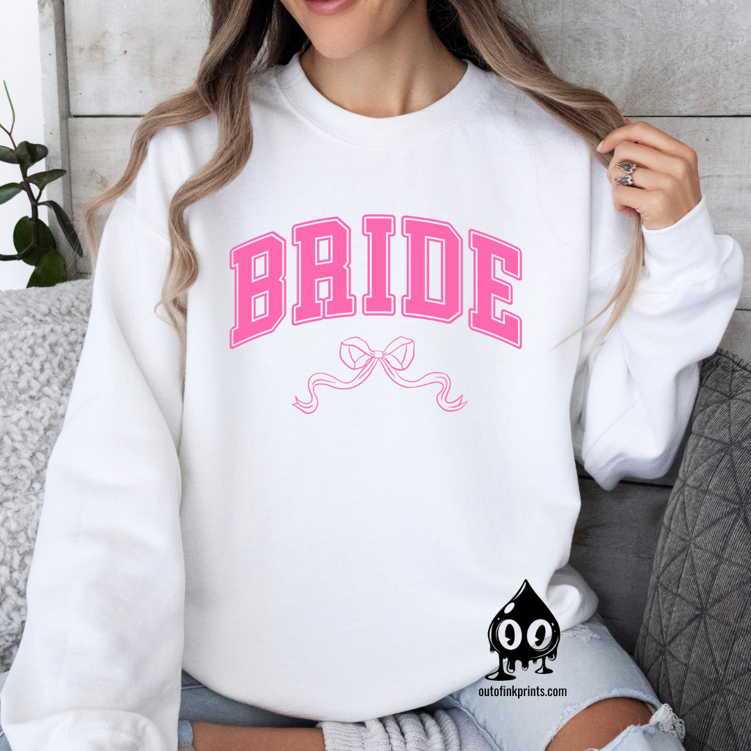 Front view of a white sweatshirt with the word 'Bride' and a pink bow on it.