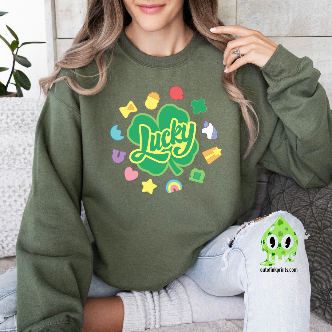 Front view of a green sweatshirt with a graphic that includes the text 'Lucky' and various colorful shapes like stars and hearts.