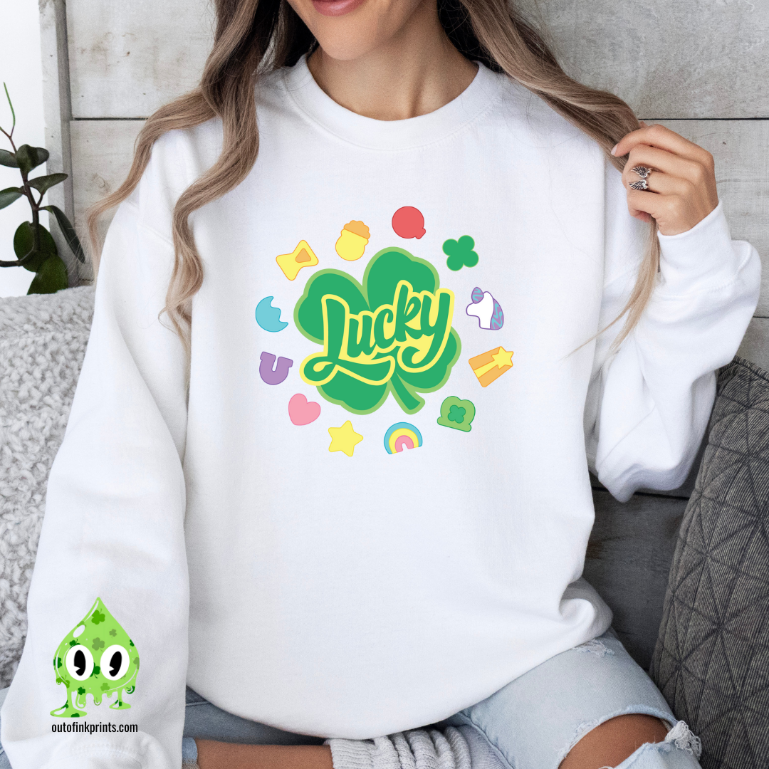 Front view of a white sweatshirt with a graphic that includes the text 'Lucky' and various colorful shapes like stars and hearts.