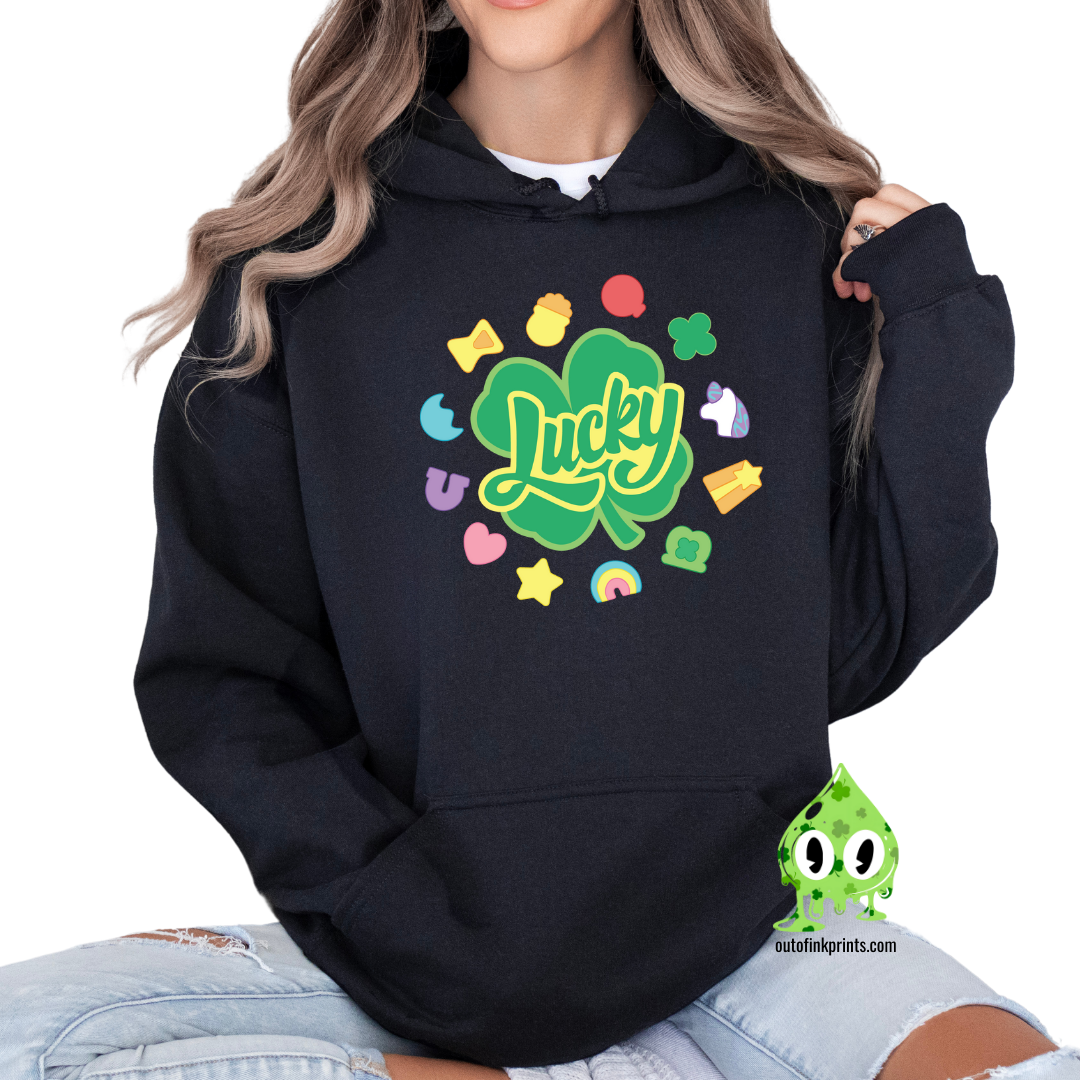 A black hoodie with a 'Lucky Marshmallows' graphic in green, featuring clovers and other St. Patrick's Day themed elements.