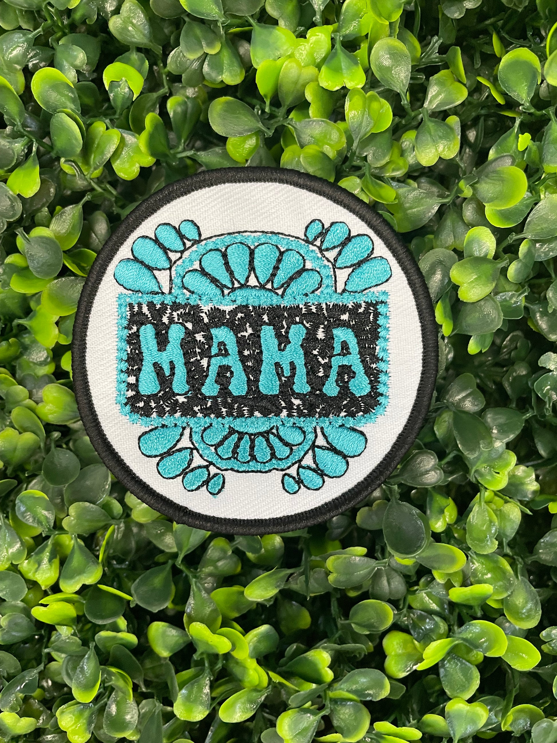 Circular patch with 'MAMA' text on a green leafy background