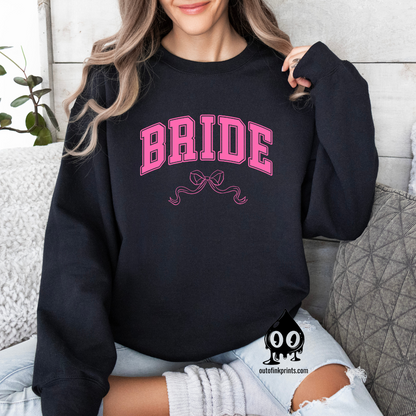 Front view of a black sweatshirt with the word 'Bride' and a pink bow on it.