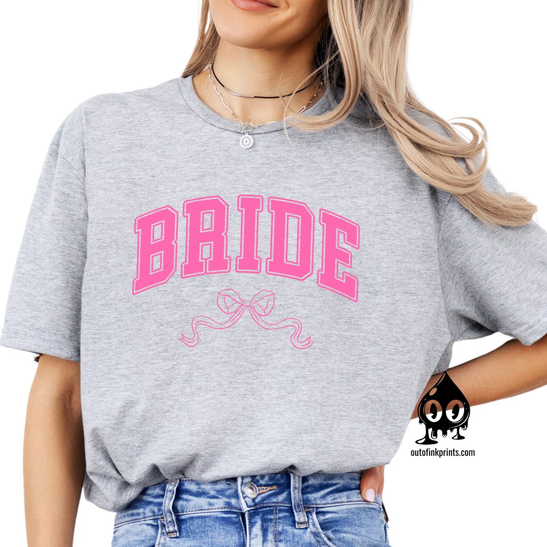 Front view of a gray t-shirt with the word 'Bride' and a pink bow graphic on it.