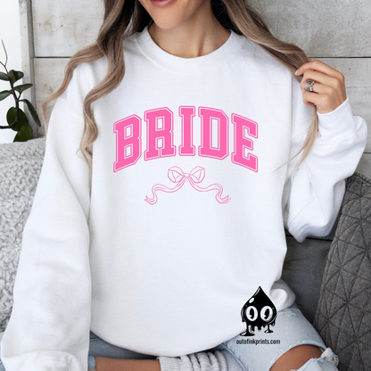 Front view of a white sweatshirt with the word 'Bride' and a pink bow on it.