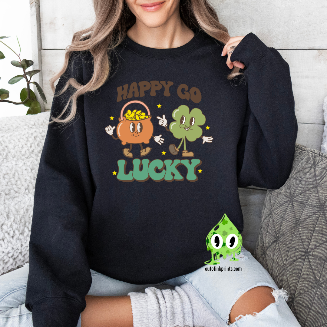 A woman wearing a black sweatshirt with the text 'HAPPY GO LUCKY' and a graphic of a smiling face and a four leaf clover.