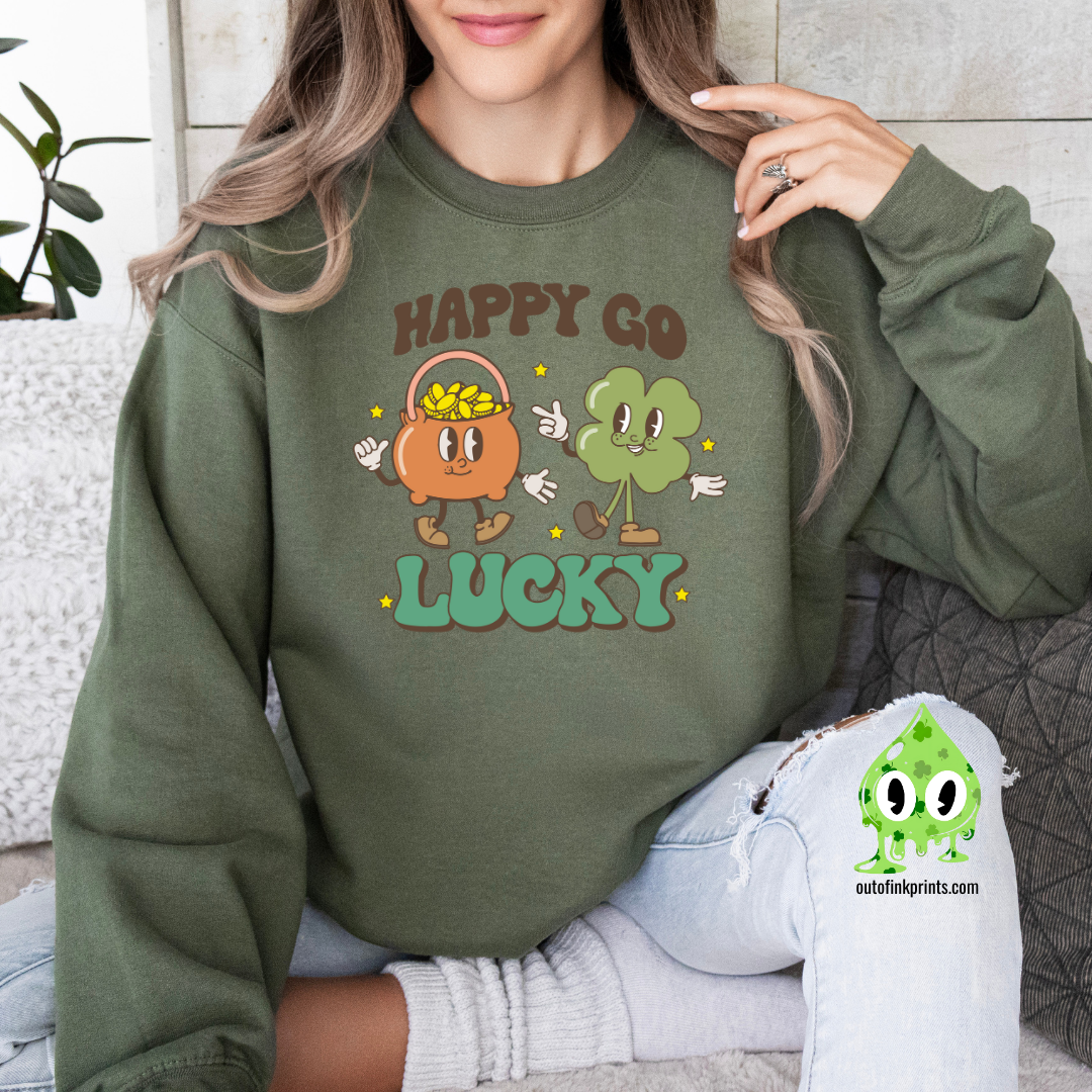 A woman wearing a green sweatshirt with the text 'HAPPY GO LUCKY' and a graphic of a smiling face and a four leaf clover.