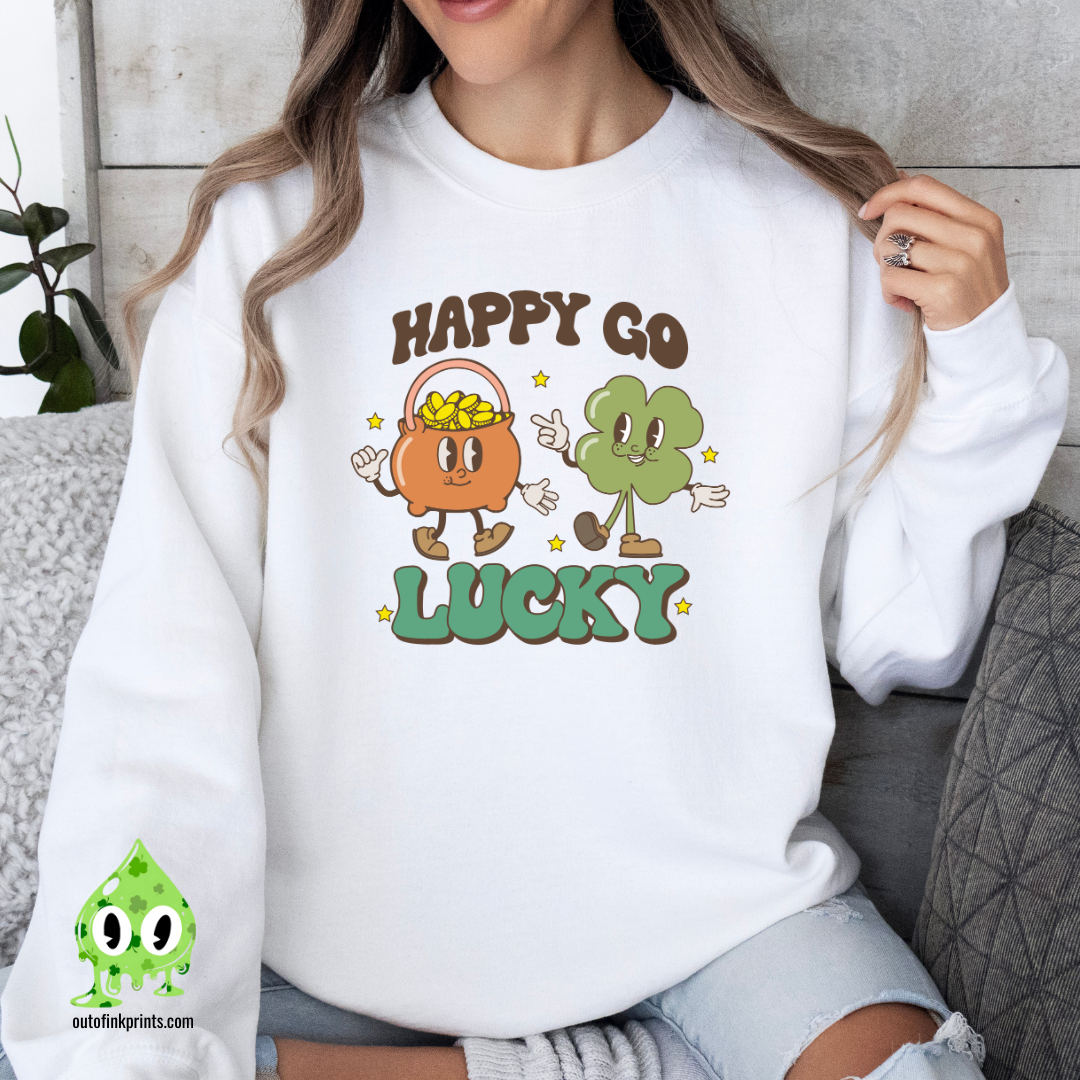 A woman wearing a white sweatshirt with the text 'HAPPY GO LUCKY' and a graphic of a smiling face and a four leaf clover.