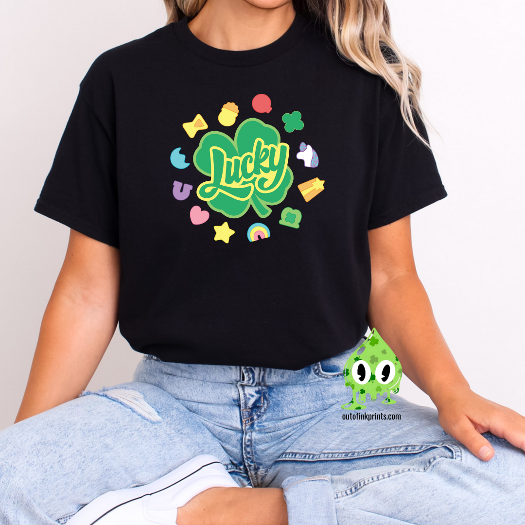 Front view of a black t-shirt with the text 'Lucky Marshmallows' and various colorful graphic elements.