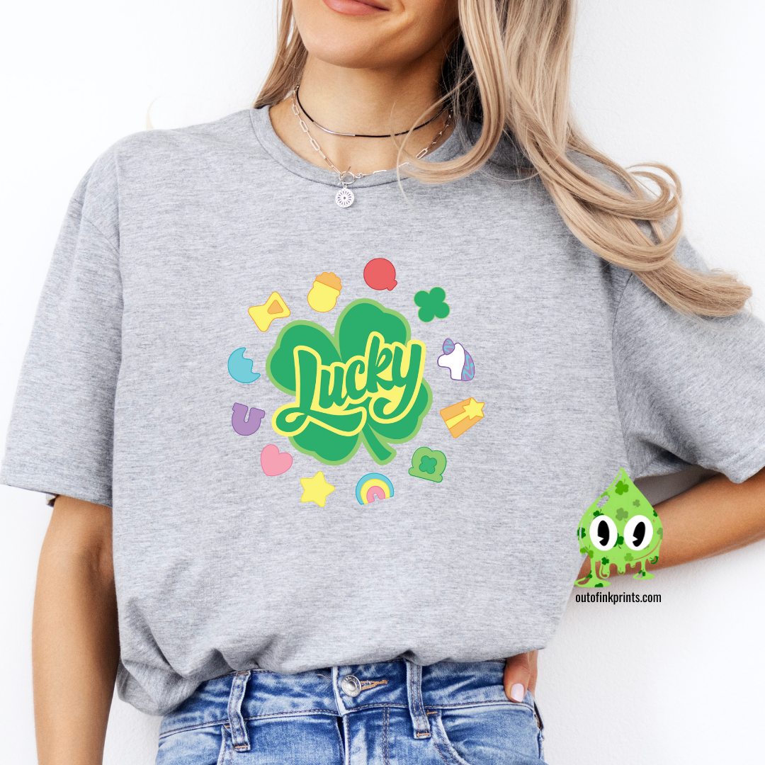 Front view of a gray t-shirt with the text 'Lucky Marshmallows' and various colorful graphic elements.