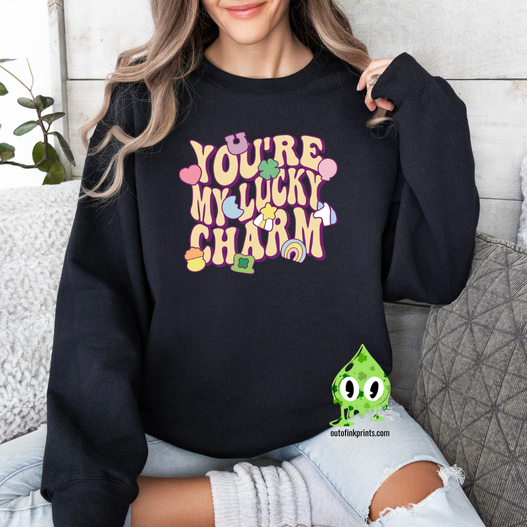 Front view of a black sweatshirt with the text 'YOU'RE MY LUCKY CHARM' printed on the front.