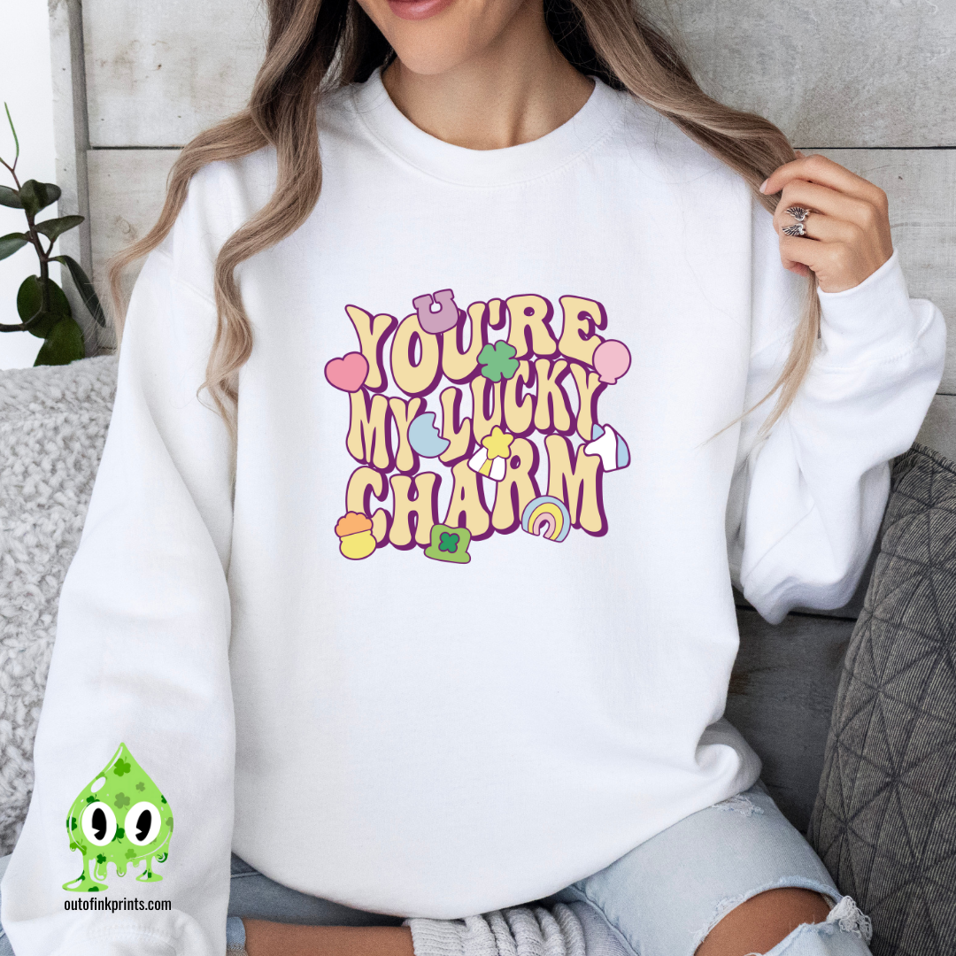Front view of a white sweatshirt with the text 'YOU'RE MY LUCKY CHARM' printed on the front.