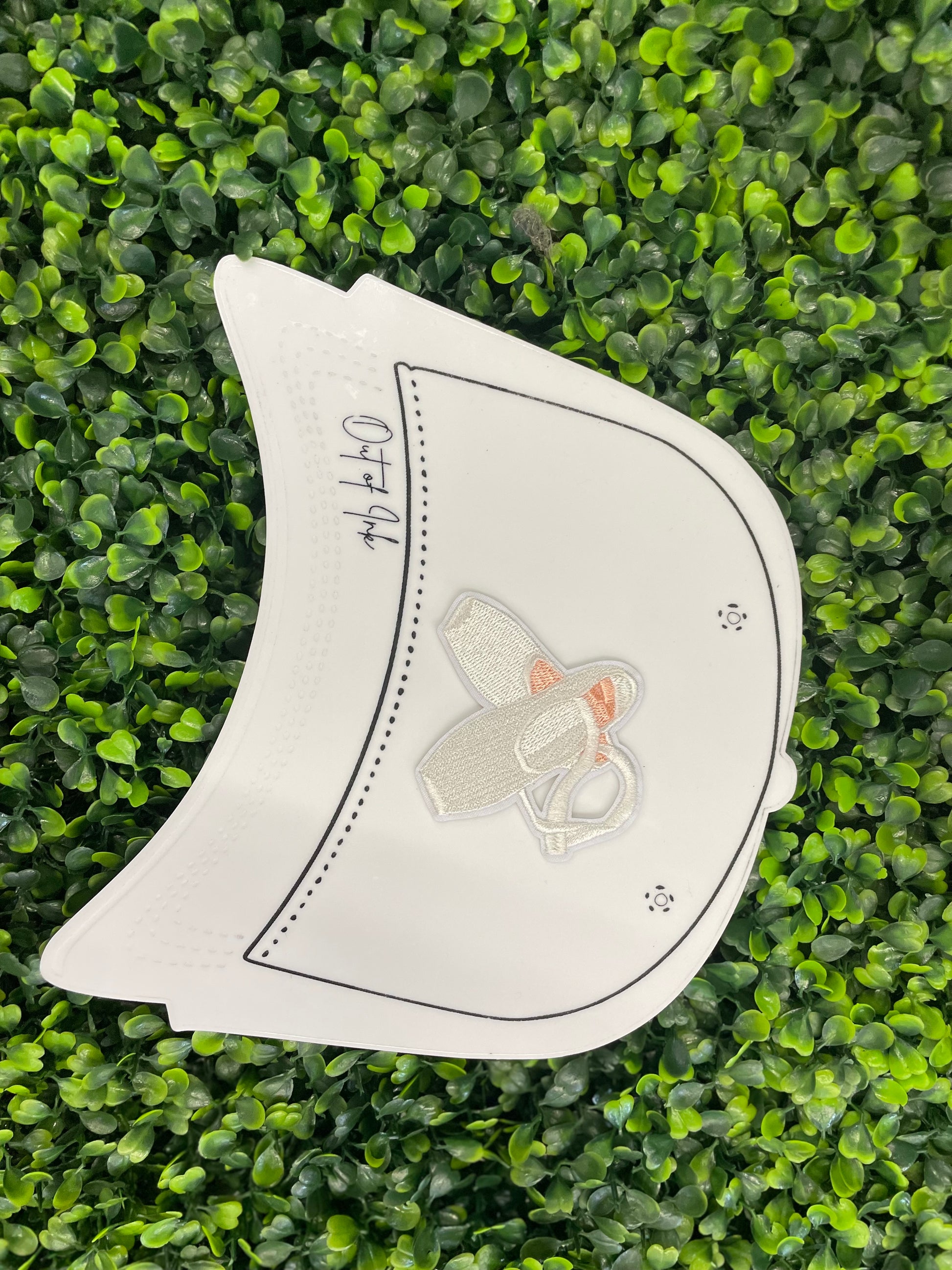 Embroidered patch of a pair of ballet slippers placed onto a white trucker hat graphic