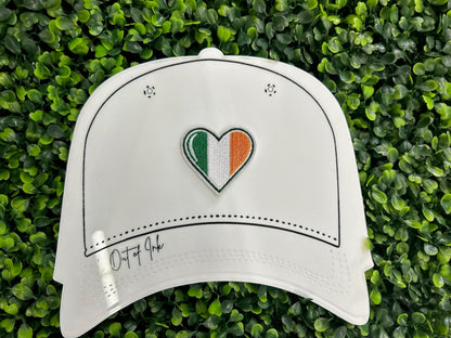 Heart shaped embroidered patch with Ireland flag colors green white and orange held on a white hat graphic